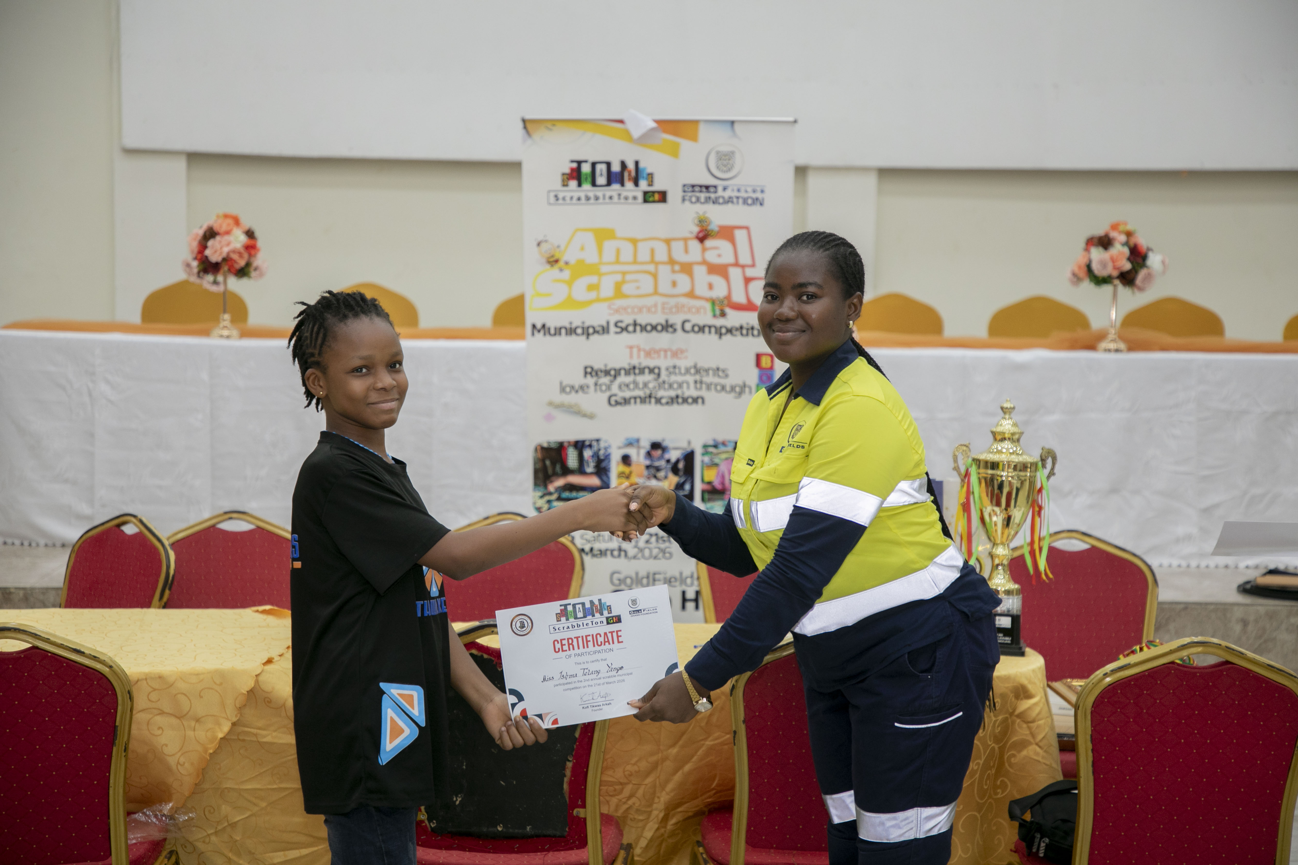 A young Scrabble champion receiving her certificate